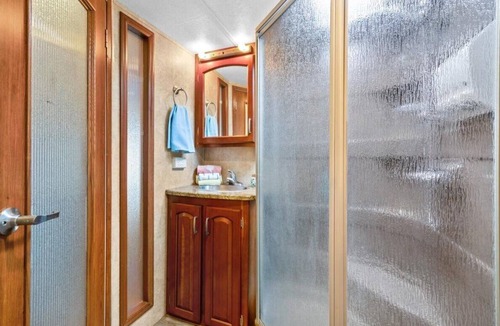 Milton RV Rental | THIS IS AN AWESOME 36' RENTAL CAMPER WITH AMAZING LONG DECK, PLUS A SECOND STEP-DOWN DECK TO YOUR OWN PRIVATE HIDEAWAY TIKI BAR! A BEAUTIFUL HUGE LIVE OAK COVERS THE ENTIRE LOT SO IT'S ALWAYS SHADED, AND THIS EVEN COMES WITH A TABLE & CHAIRS FOR OUT