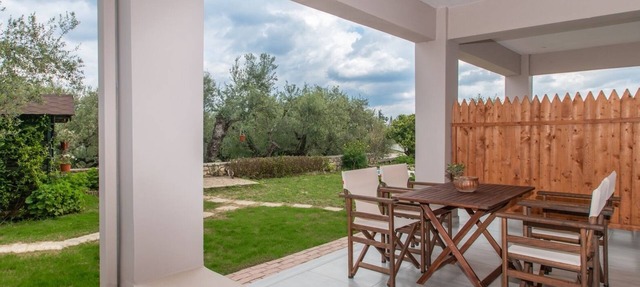Nestled on the ground floor with direct garden access amidst olive trees in Psarou