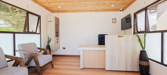 Rustic A-frame cabins blending natural wood,glass and serene outdoor living in Nakuru County