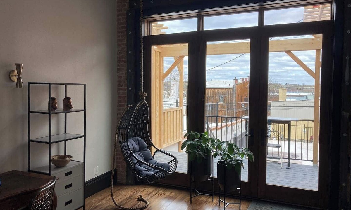 Sheridan Apartment | Luxurious industrial-chic loft in historic downtown Sheridan. This stunning 2-bedroom, 2-bath apartment sleeps up to 9, featuring 2 king suites, 2 1/2 bathrooms sleeping alcove, modern kitchen, fireplace, & Main Street balcony views.